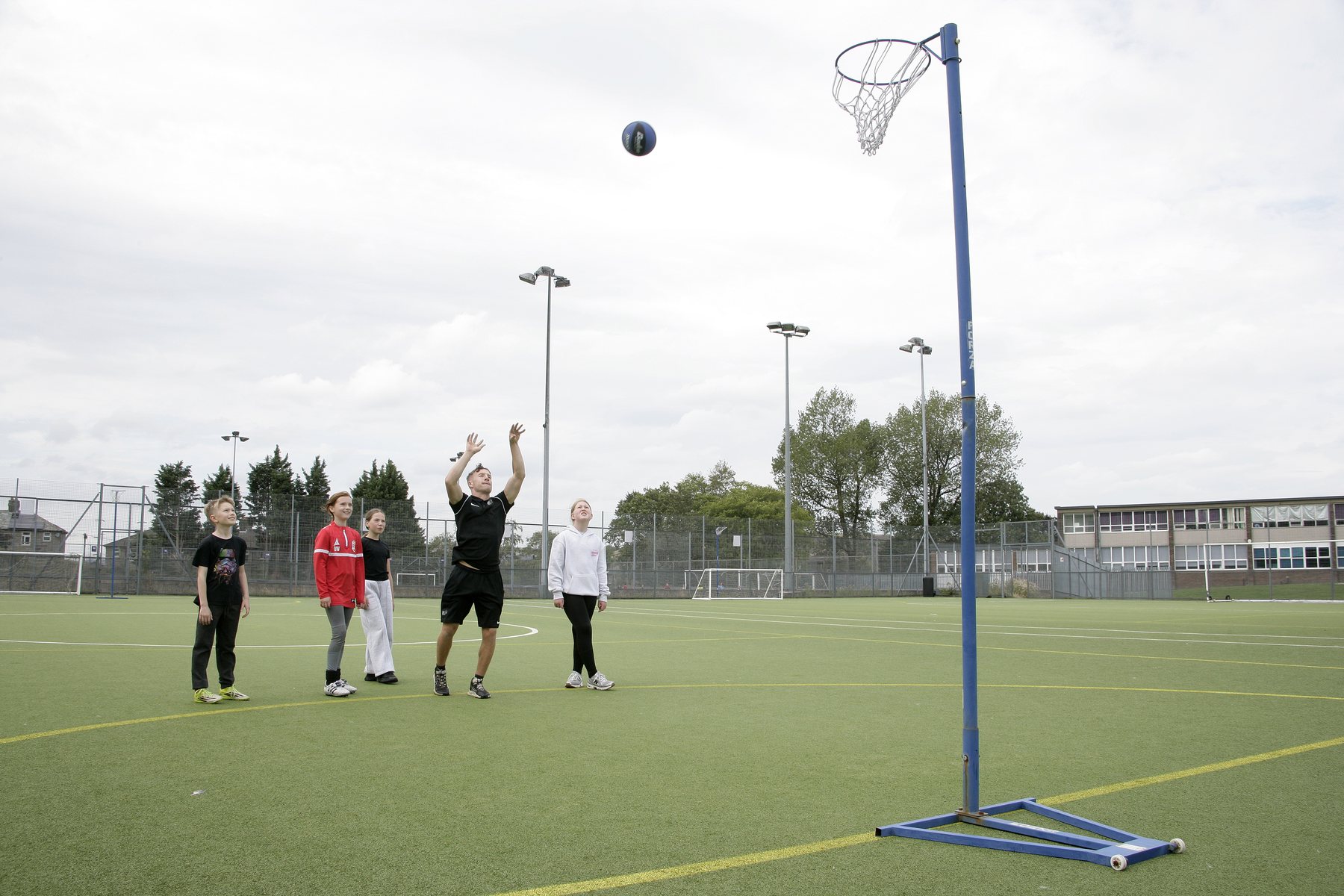 Children playing basketball on the outdoor court