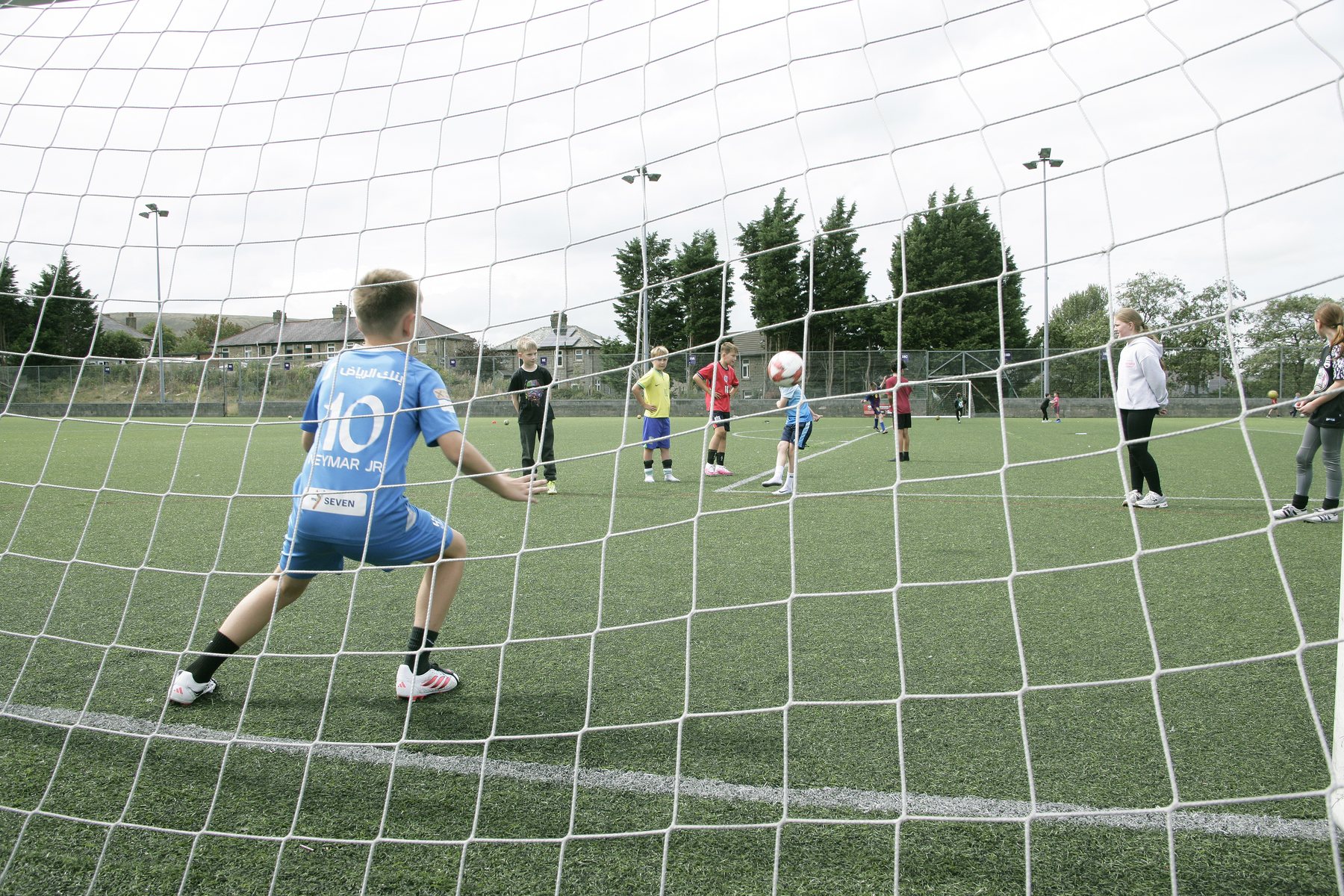 Children playing football at a Get Into Sport holiday camp
